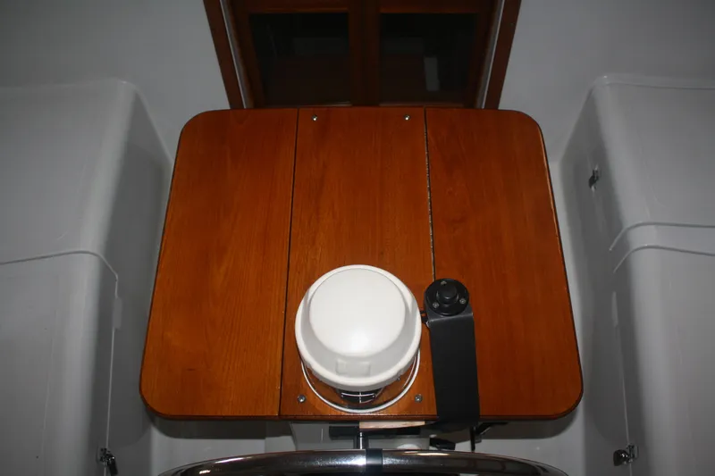 Slide: The Image of 1978 Bombay Clipper Sloop interior with wooden table and navigation equipment. - 42