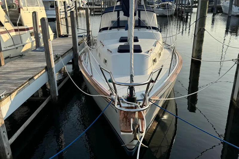 Slide: The Image of 1978 Bombay Clipper Sloop docked at marina, front view. - 43