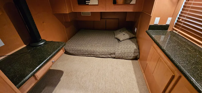 Slide: The Image of Interior of 2000 Sumerset Houseboat, featuring cozy sleeping area and granite countertops. - 13
