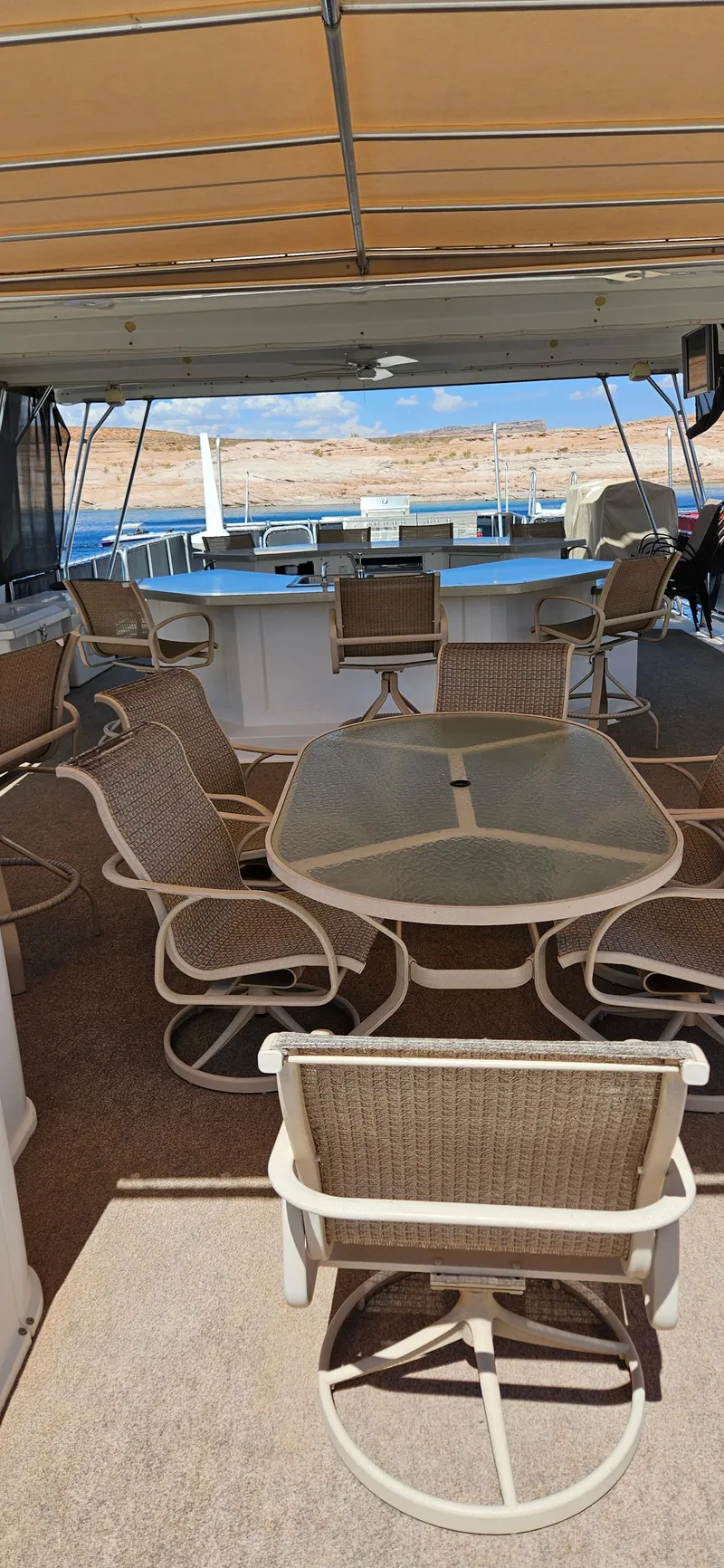 Slide: The Image of Spacious deck of 2000 Sumerset Houseboat 21' x 75' with outdoor seating and canopy. - 18