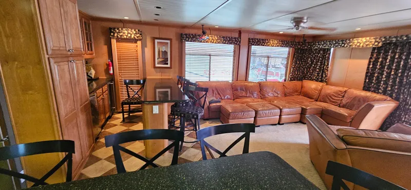 Slide: The Image of Luxurious interior of a 2000 Sumerset Houseboat, featuring a spacious living area with leather seating. - 4