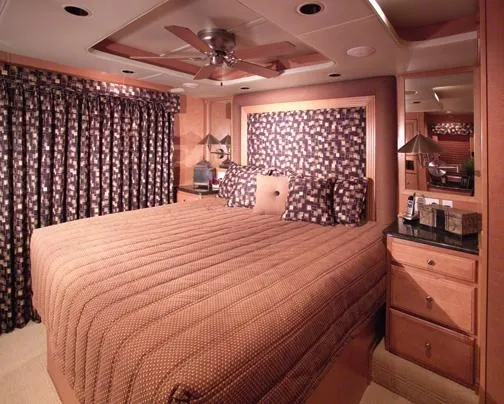 Slide: The Image of Luxurious bedroom interior of a 2000 Sumerset Houseboat, featuring a large bed and elegant decor. - 9