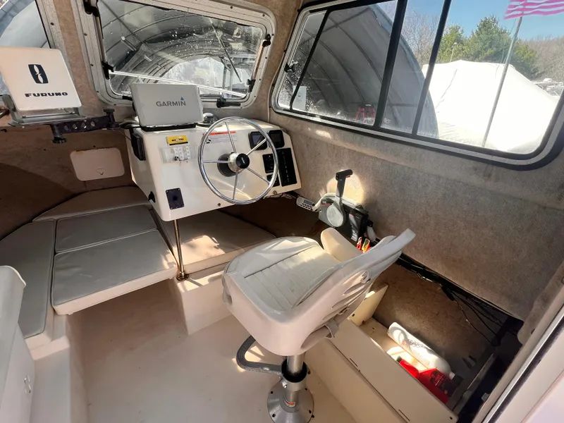 Slide: The Image of 2006 Parker 2320 SL Sport Cabin interior with steering wheel and navigation equipment. - 2