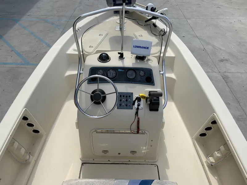 Slide: The Image of 2003 Sea Chaser 190 Bay boat interior with steering wheel and control panel. - 10