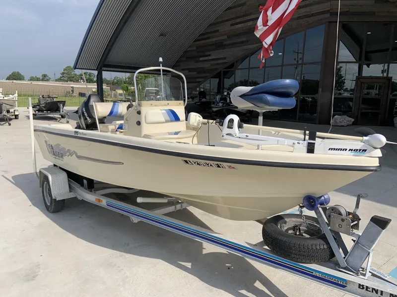 Slide: The Image of 2003 Sea Chaser 190 Bay boat on trailer, parked outdoors under a metal canopy. - 18
