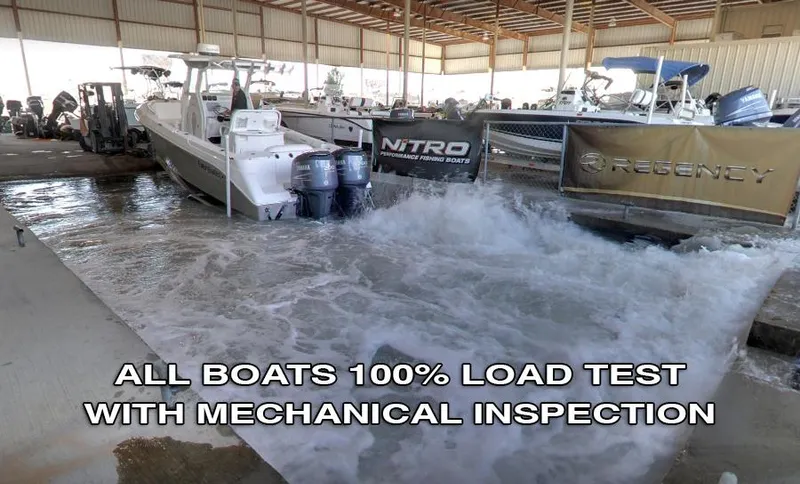 Slide: The Image of 2003 Sea Chaser 190 Bay undergoing load test and mechanical inspection in a boat facility. - 2