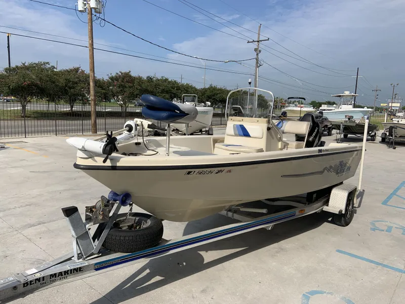 Slide: The Image of 2003 Sea Chaser 190 Bay boat on trailer in parking lot, clear sky background. - 20