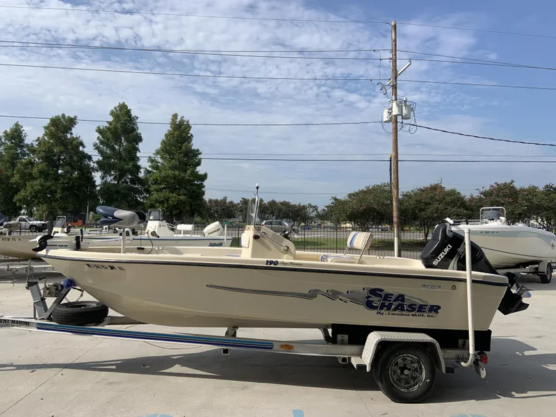 Slide: The Image of 2003 Sea Chaser 190 Bay boat on trailer, parked outdoors under a clear sky. - 4