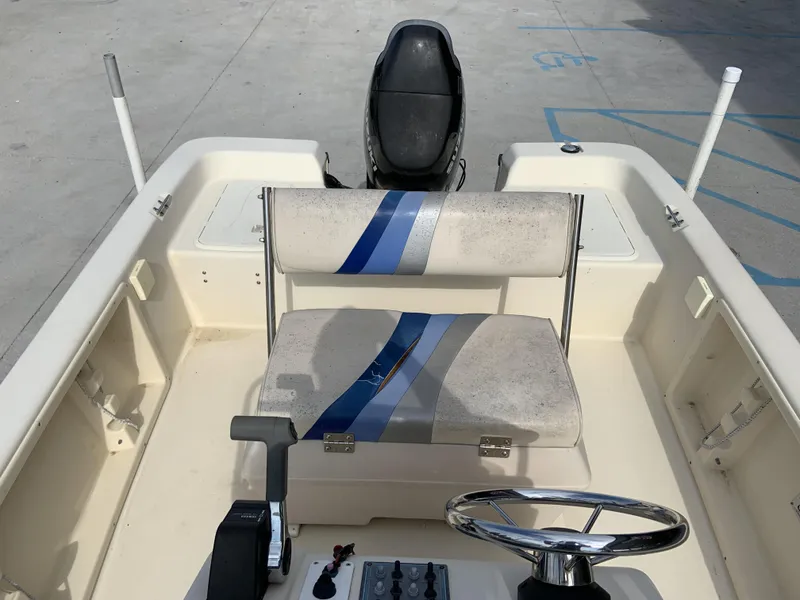 Slide: The Image of 2003 Sea Chaser 190 Bay boat interior with steering wheel and seating. - 8