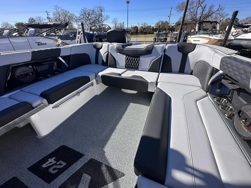 Slide: The Image of 2025 MasterCraft X24 boat interior with sleek gray seating and modern design. - 12
