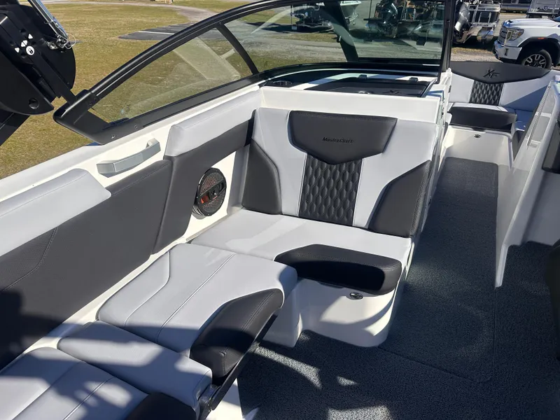 Slide: The Image of 2025 MasterCraft X24 boat interior with sleek, modern seating and stylish design. - 13