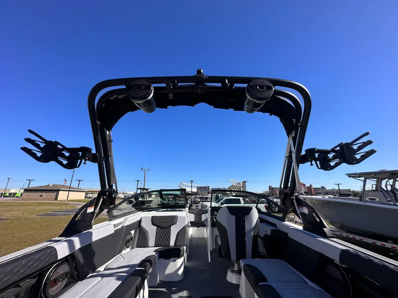 Slide: The Image of 2025 MasterCraft X24 boat interior with wakeboard tower under clear blue sky. - 15