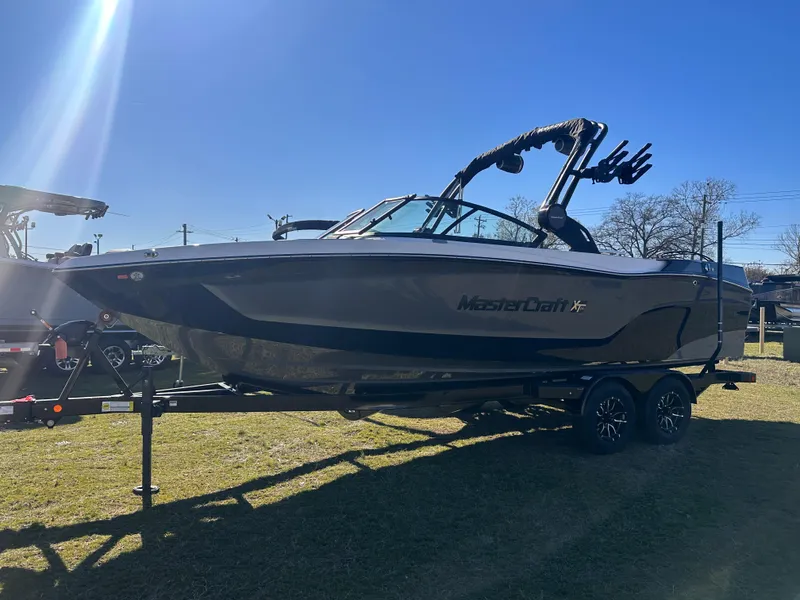 Slide: The Image of 2025 MasterCraft X24 boat on trailer, side view in sunlight. - 4