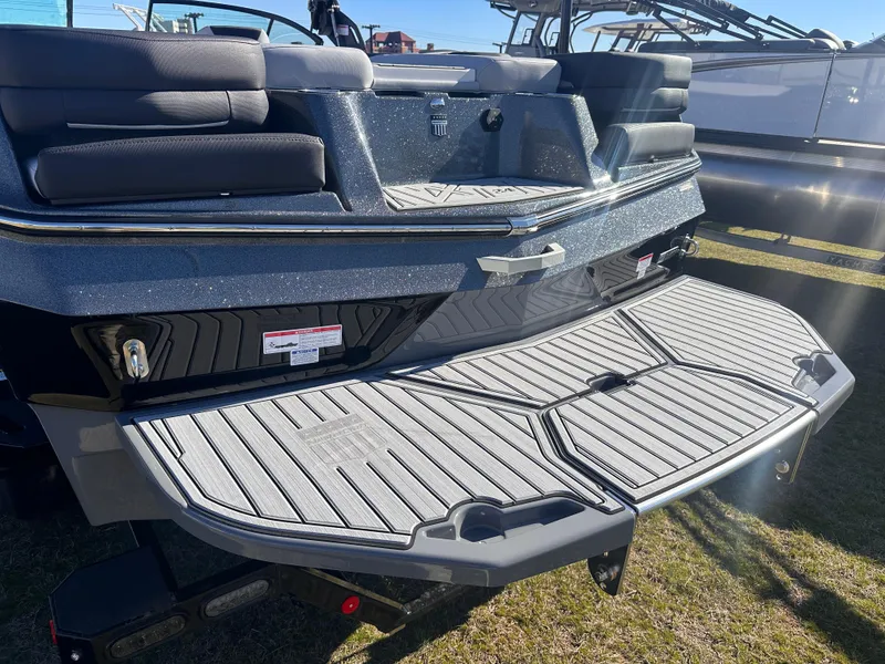 Slide: The Image of 2025 MasterCraft X24 boat with spacious rear deck and cushioned seating. - 5