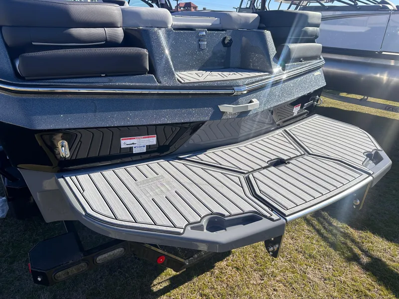 Slide: The Image of 2025 MasterCraft X24 boat with spacious rear deck and seating, displayed outdoors. - 6
