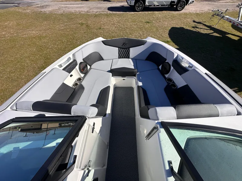 Slide: The Image of 2025 MasterCraft X24 boat interior with spacious seating and cup holders. - 9