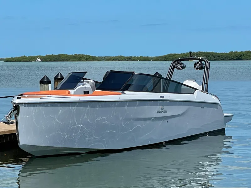 The Image of 2022 Cranchi 26 Rider boat docked on calm water, featuring sleek design and modern amenities. - 0