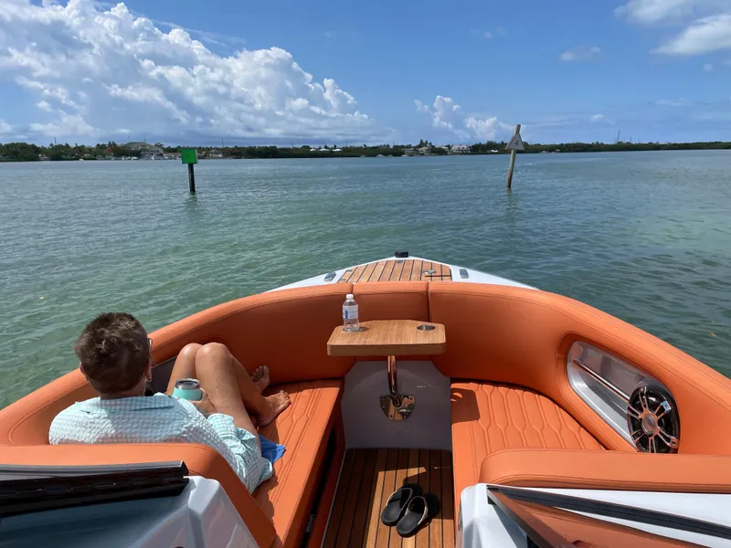 Slide: The Image of Man relaxing on 2022 Cranchi 26 Rider boat, enjoying sunny day on the water. - 13