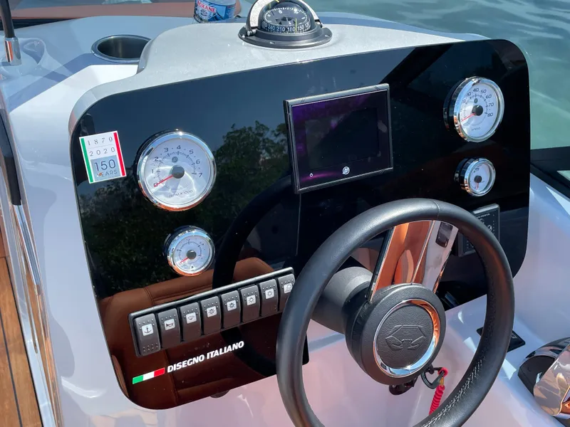 Slide: The Image of Dashboard of 2022 Cranchi 26 Rider boat with gauges and steering wheel. - 19