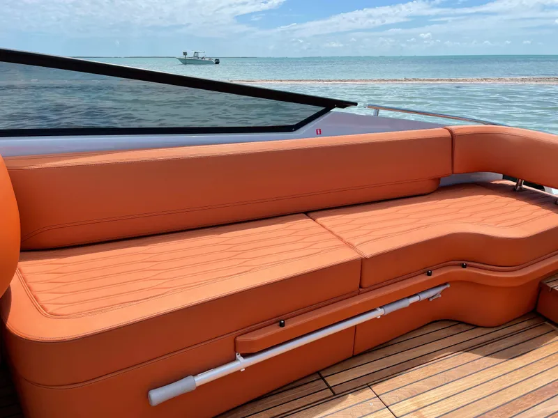 Slide: The Image of 2022 Cranchi 26 Rider boat with orange seating, ocean view in background. - 28