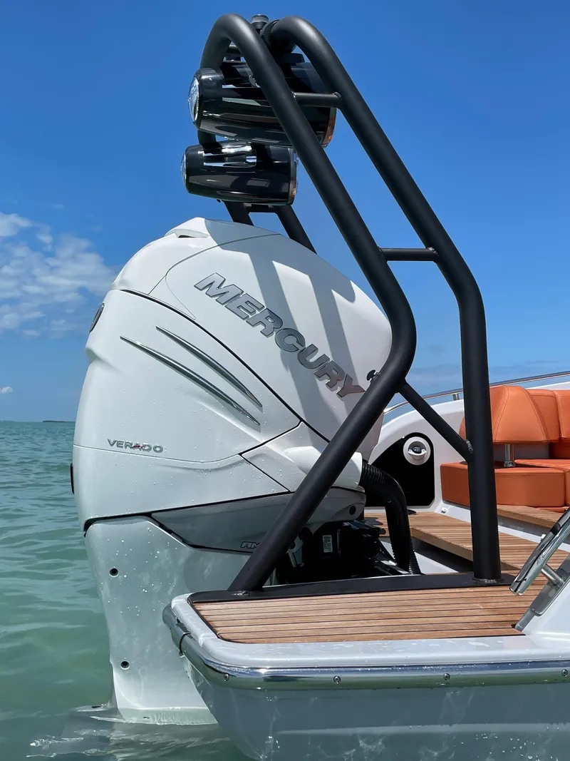 Slide: The Image of 2022 Cranchi 26 Rider boat with Mercury engine, docked on calm water. - 37