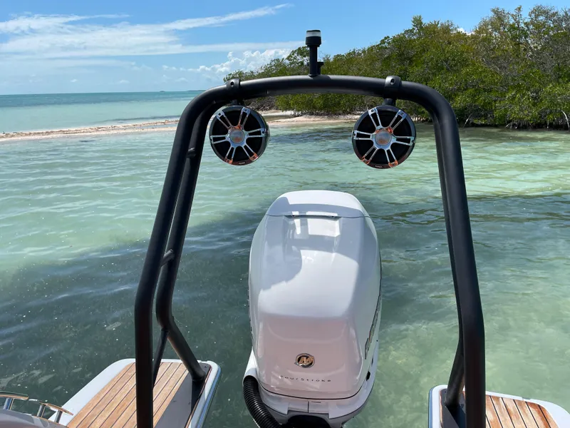 Slide: The Image of 2022 Cranchi 26 Rider boat with outboard motor, near tropical shoreline. - 38