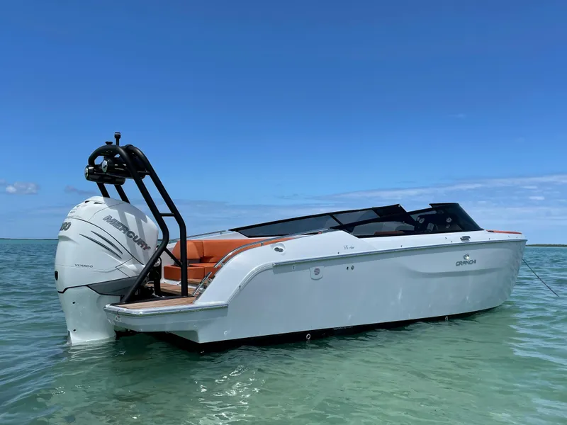 Slide: The Image of 2022 Cranchi 26 Rider boat on clear water under blue sky. - 4