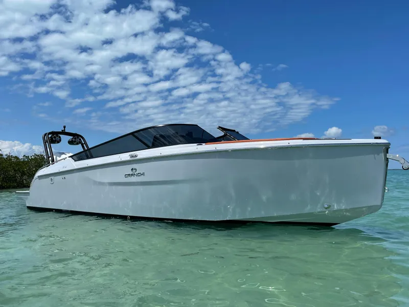 Slide: The Image of 2022 Cranchi 26 Rider boat on clear water under blue sky. - 7