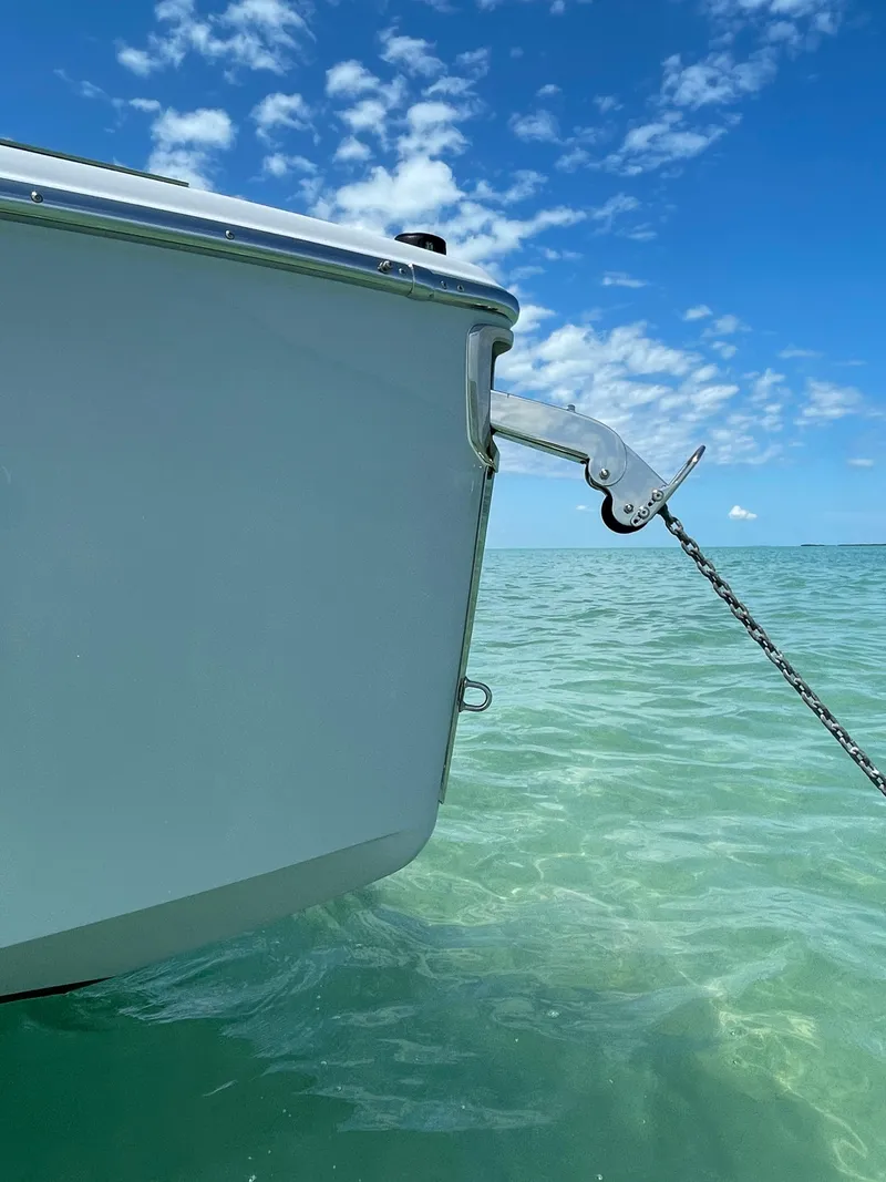 Slide: The Image of 2022 Cranchi 26 Rider boat anchored in clear turquoise water under a blue sky. - 8