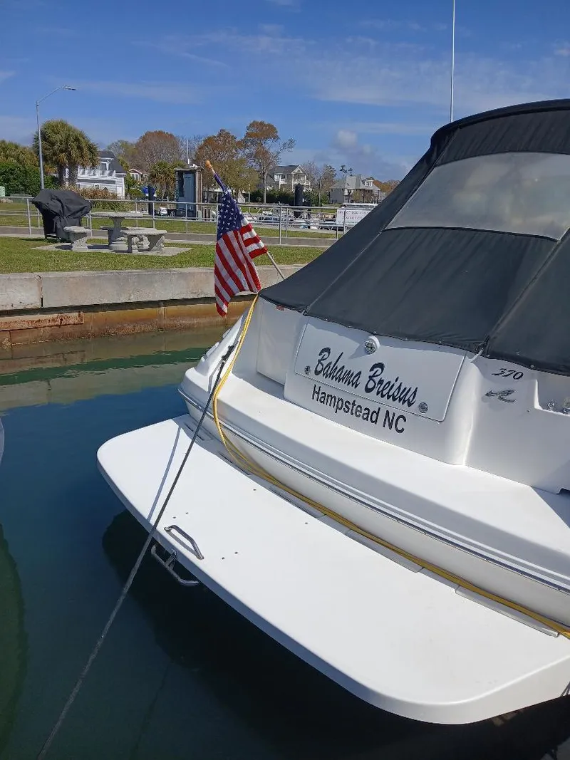 Slide: The Image of 1997 Sea Ray 370 Sundancer docked, displaying American flag, Hampstead NC. - 3