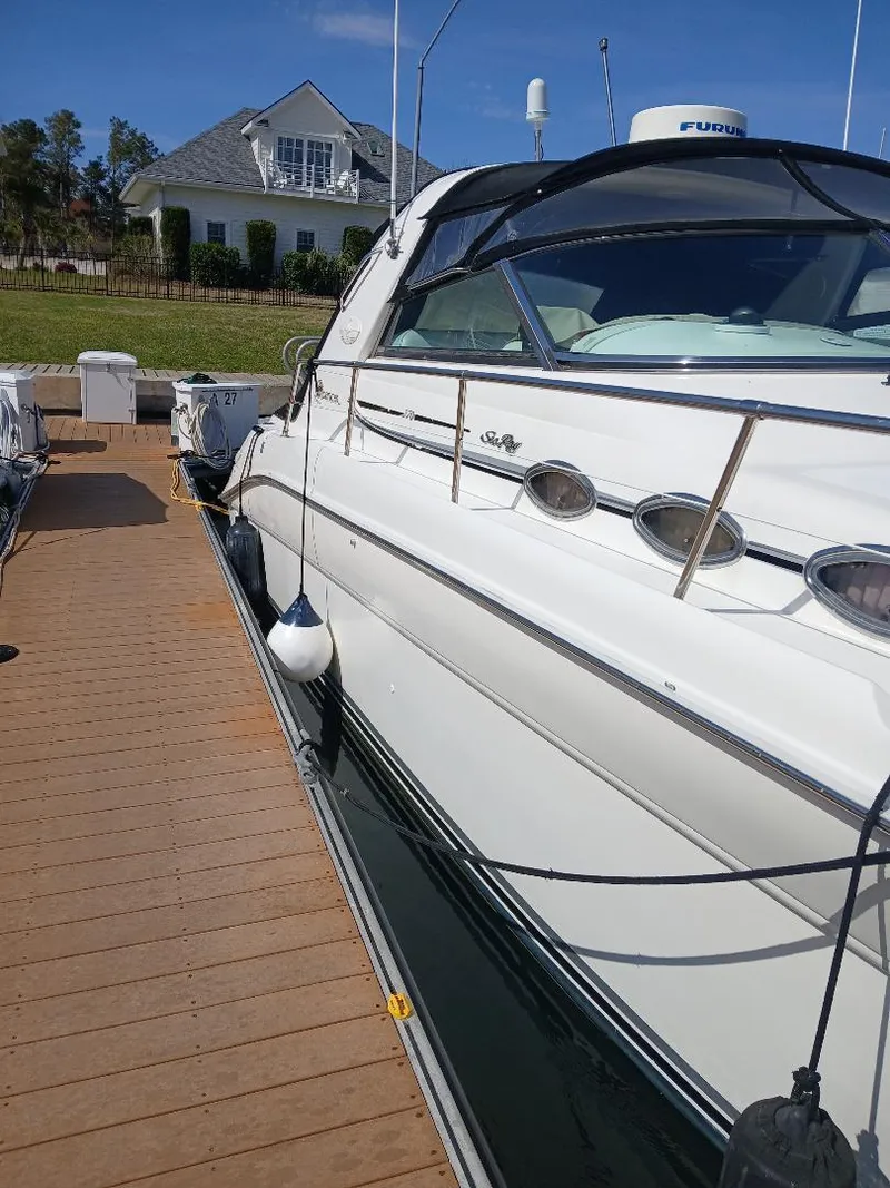 Slide: The Image of 1997 Sea Ray 370 Sundancer docked, showcasing sleek design and luxury features. - 4