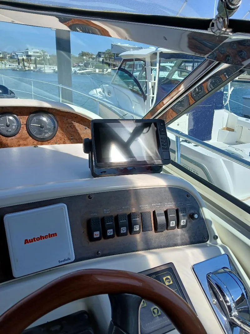 Slide: The Image of 1997 Sea Ray 370 Sundancer helm with navigation controls and Autopilot system. - 6