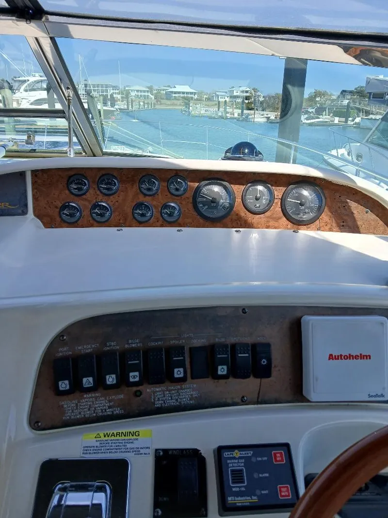 Slide: The Image of Control panel of a 1997 Sea Ray 370 Sundancer boat, docked at a marina. - 7
