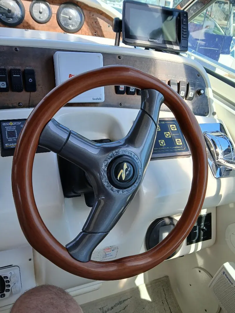 Slide: The Image of Steering wheel of a 1997 Sea Ray 370 Sundancer boat with control panel. - 9