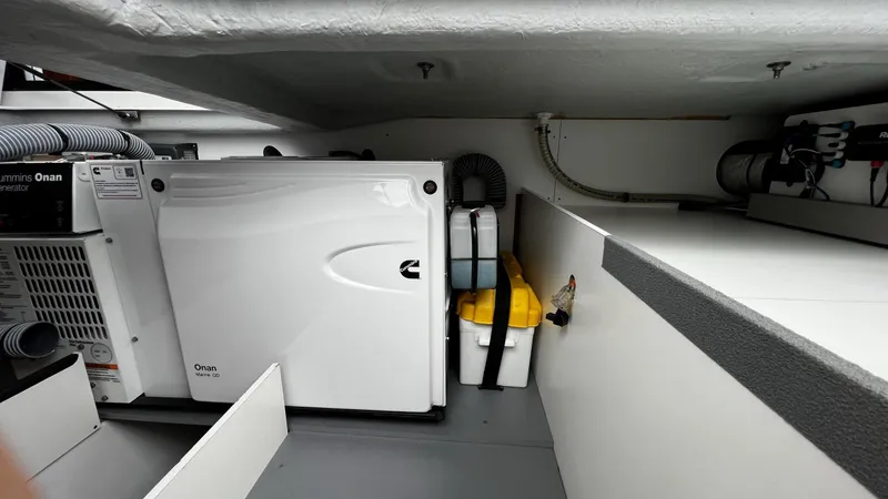Slide: The Image of Engine room of 2020 Beneteau Swift Trawler 44 with Onan generator and storage. - 21