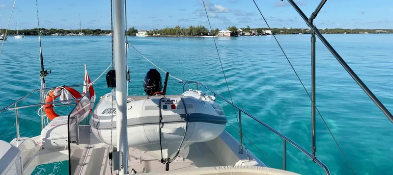Slide: The Image of Beneteau Swift Trawler 44, 2020 model, cruising on clear turquoise waters near a distant shoreline. - 22
