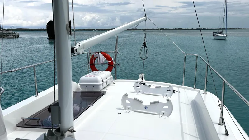 Slide: The Image of 2020 Beneteau Swift Trawler 44 on calm waters, featuring spacious deck and safety equipment. - 23