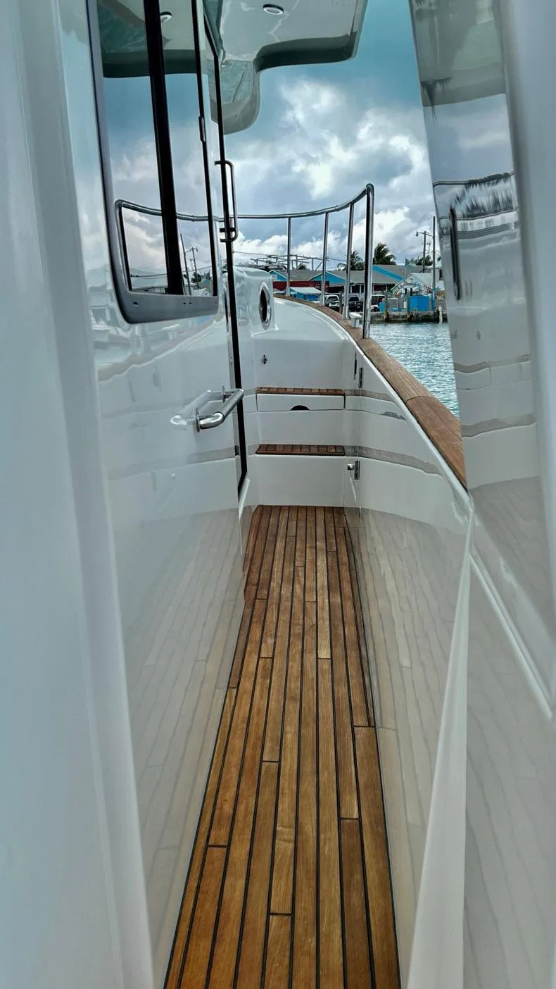 Slide: The Image of 2020 Beneteau Swift Trawler 44, side deck view with wooden flooring and railing. - 39