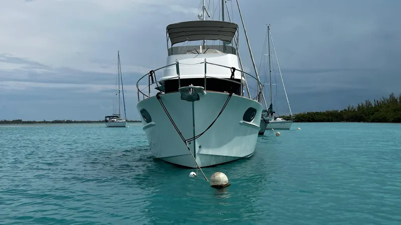 Slide: The Image of 2020 Beneteau Swift Trawler 44 anchored in turquoise waters, front view. - 4