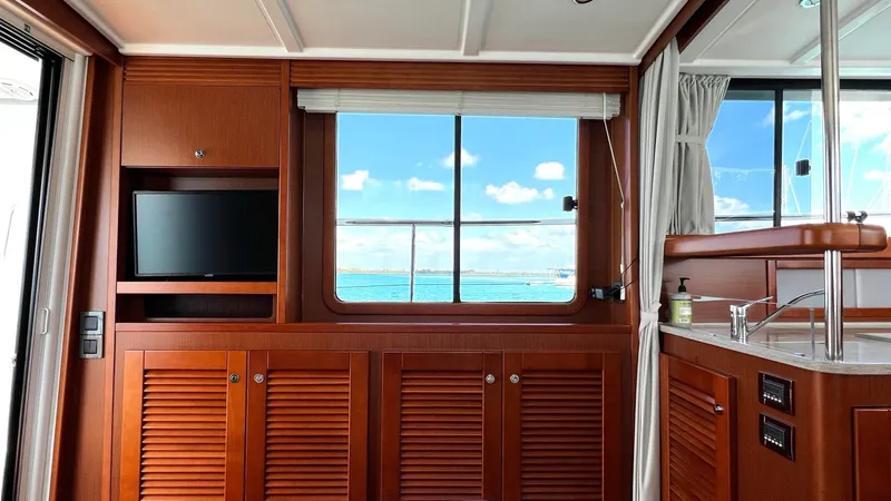 Slide: The Image of Interior of 2020 Beneteau Swift Trawler 44 with wooden cabinetry and ocean view. - 44