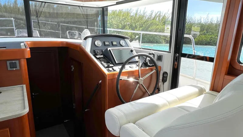 Slide: The Image of 2020 Beneteau Swift Trawler 44 helm with modern controls and comfortable seating. - 49
