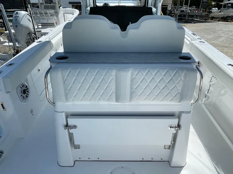 Slide: The Image of 2024 Everglades 285CC boat interior with cushioned seating and storage. - 10