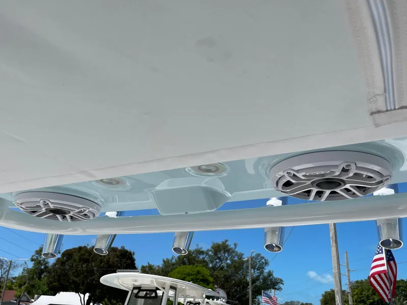 Slide: The Image of Speakers and rod holders on 2024 Everglades 285CC boat, under clear blue sky. - 14
