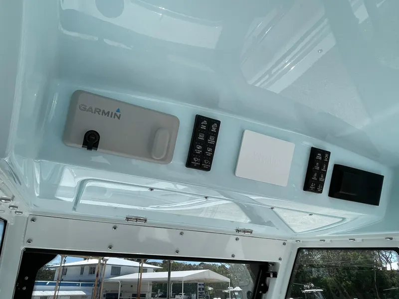 Slide: The Image of 2024 Everglades 285CC boat dashboard with Garmin electronics and control panels. - 15