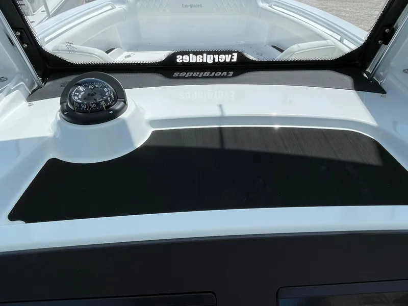 Slide: The Image of 2024 Everglades 285CC boat dashboard with compass and windshield. - 17