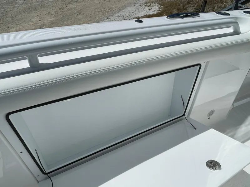 Slide: The Image of 2024 Everglades 285CC boat interior detail with open storage compartment. - 22