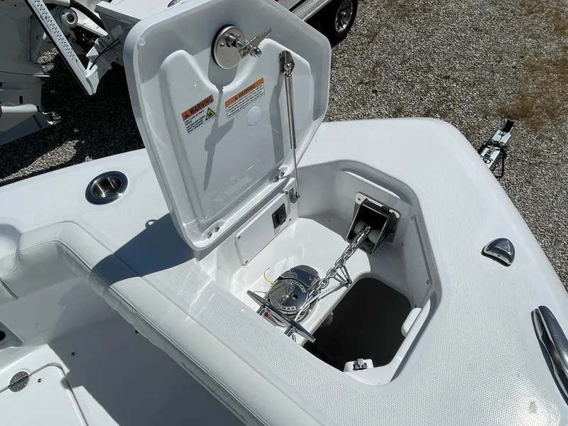 Slide: The Image of 2024 Everglades 285CC boat anchor compartment with open hatch, showcasing storage and mechanism. - 24