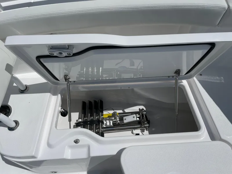 Slide: The Image of 2024 Everglades 285CC boat storage compartment with open lid, showcasing internal mechanisms. - 26