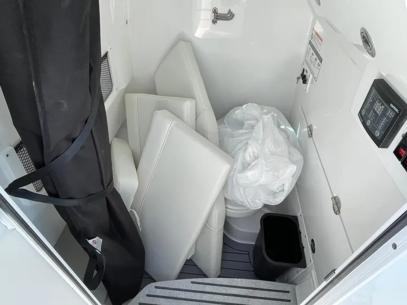 Slide: The Image of 2024 Everglades 285CC boat interior storage with cushions and equipment. - 30