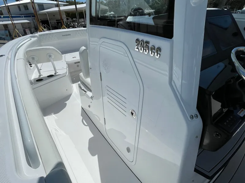 Slide: The Image of 2024 Everglades 285CC boat, white interior, sleek design, modern console, spacious seating. - 31